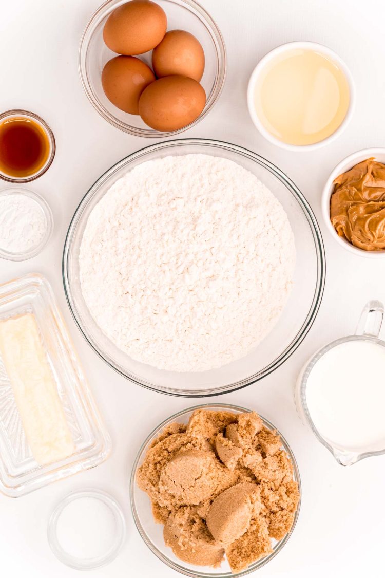 Ingredients to make peanut butter cake on a white table.