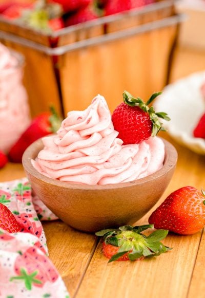 Strawberry buttercream frosting in a wooden bowl.