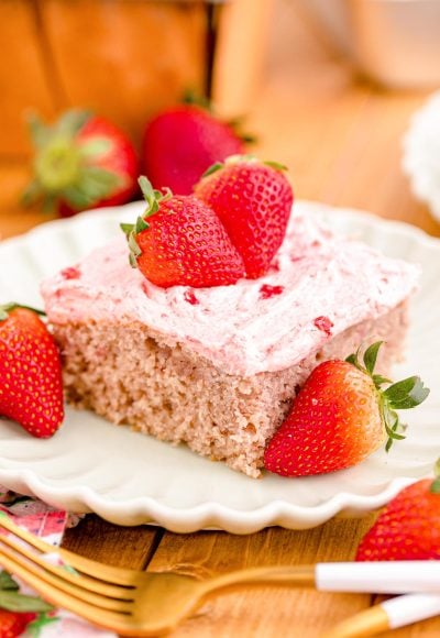 Close up photo of a slice of strawberry sheet cake on a plate.