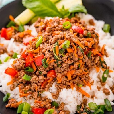 Close up photo of a bowl of Thai basil beef over white rice.