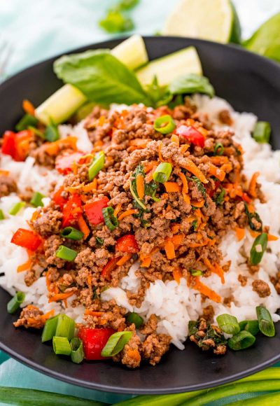 Close up photo of a bowl of Thai basil beef over white rice.