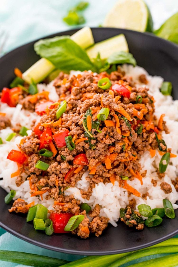 Close up photo of a bowl of Thai basil beef over white rice.