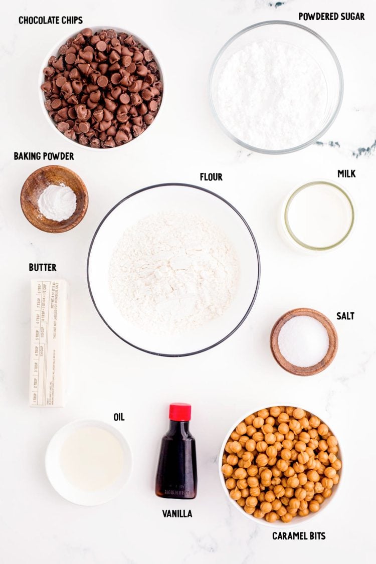 Ingredients prepped to make twix cookies on a marble counter.