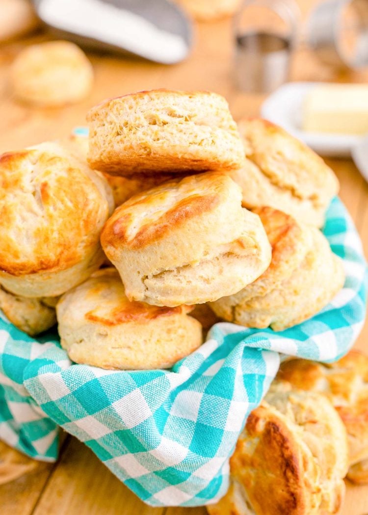 Close up photo of buttermilk biscuits in a teal and white checkered napkin.