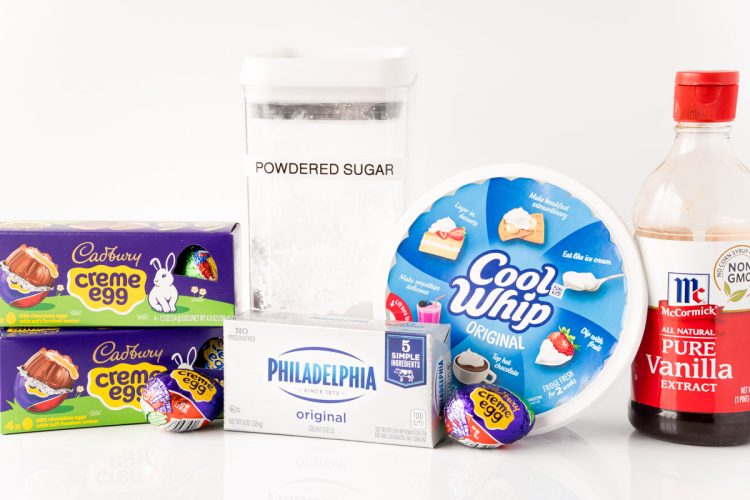 Ingredients to make cadbury creme egg dip on a white table.