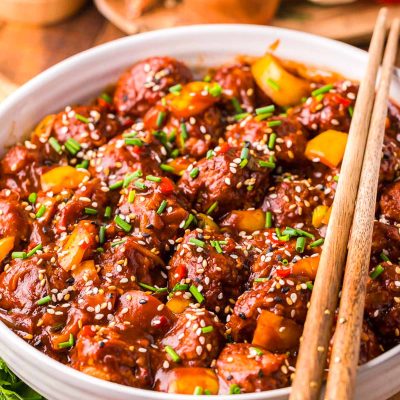 This Chicken Manchurian is a flavor-packed dish that's made with deep-fried ground chicken balls, Tamari, red chili pepper, and ginger! Prep this mouthwatering dinner option in just 15 minutes!