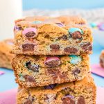 Close up of three easter blondie bars stacked on a pink napkin.