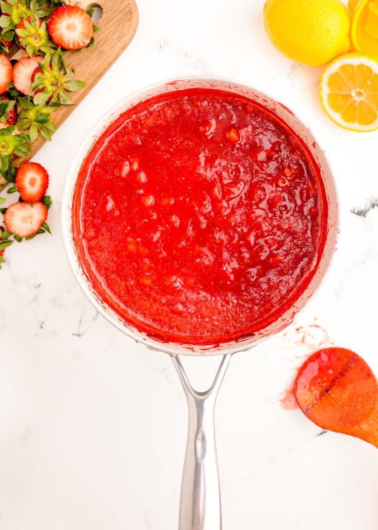 Strawberry puree in a stainless steel pot.