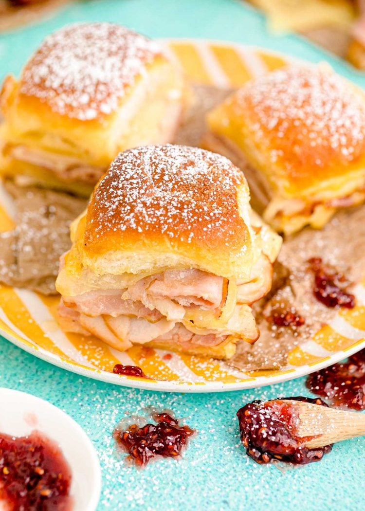 Monte Cristo Sliders on a yellow plate on a blue surface.