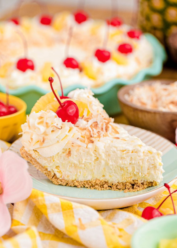 A slice of pina colada pie on a coloful plate and napkin.