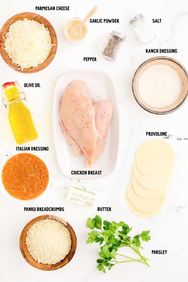 Ingredients to make parmesan crusted chicken on a marble counter.