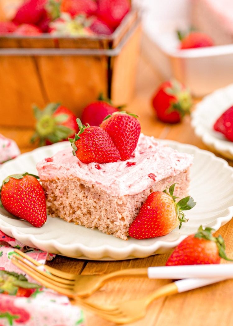 Close up photo of a slice of strawberry sheet cake on a plate.