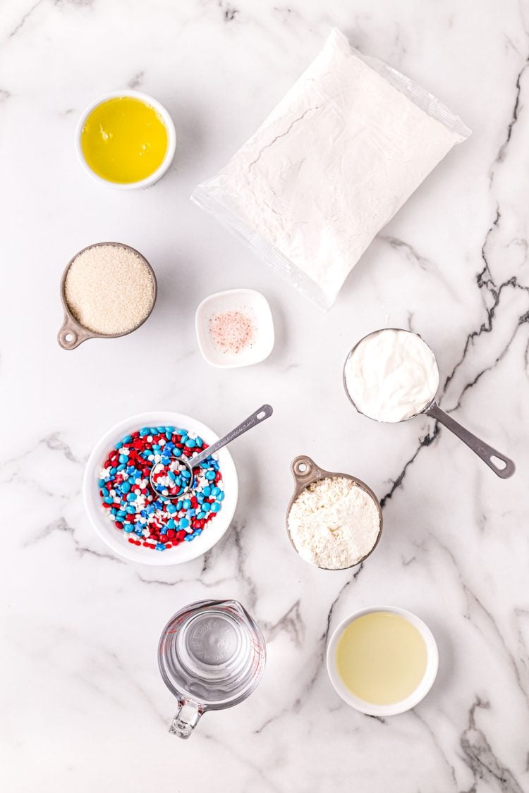 Ingredients to make 4th of July cupcakes on a marble surface.