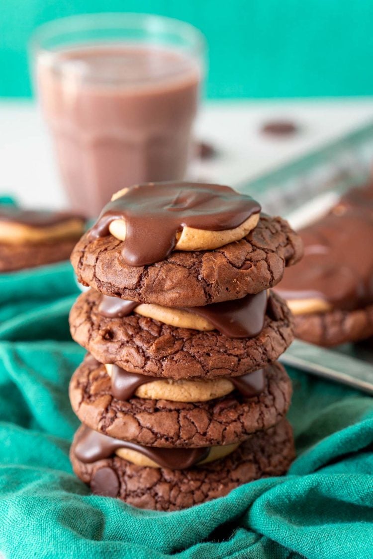 A stack of four buckeye cookies on a green napkin.