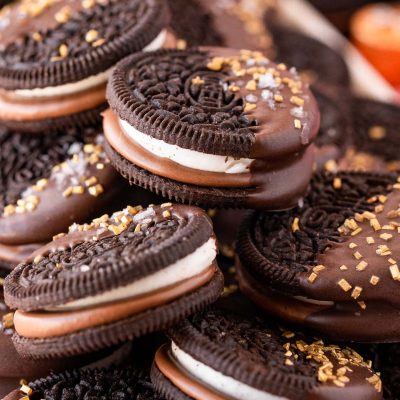 Close up of chocolate dipped oreos on a plate.