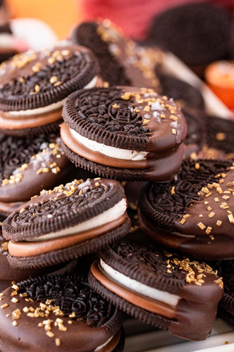 Close up of chocolate dipped oreos on a plate.