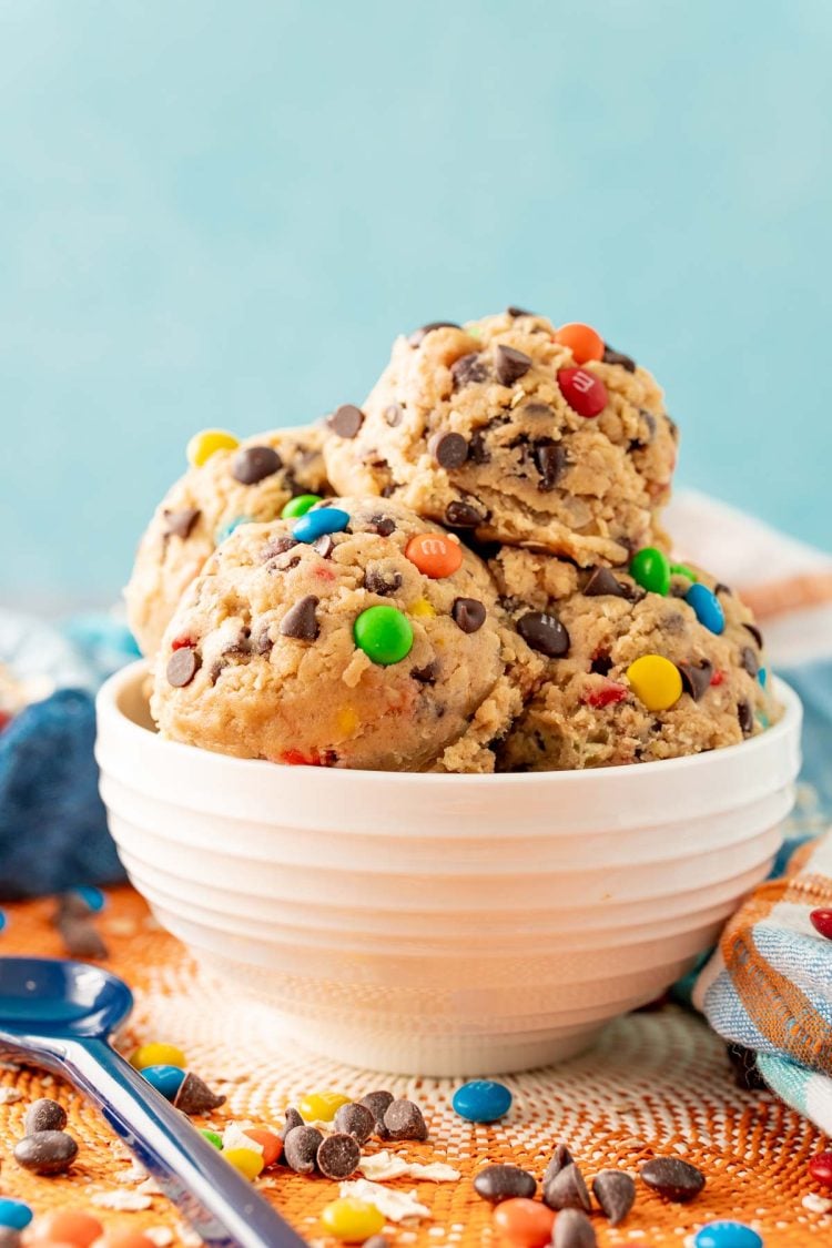 A white bowl filled with edible monster cookie dough.