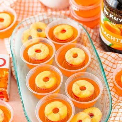 Fuzzy Navel Jello Shots on a blue plate.