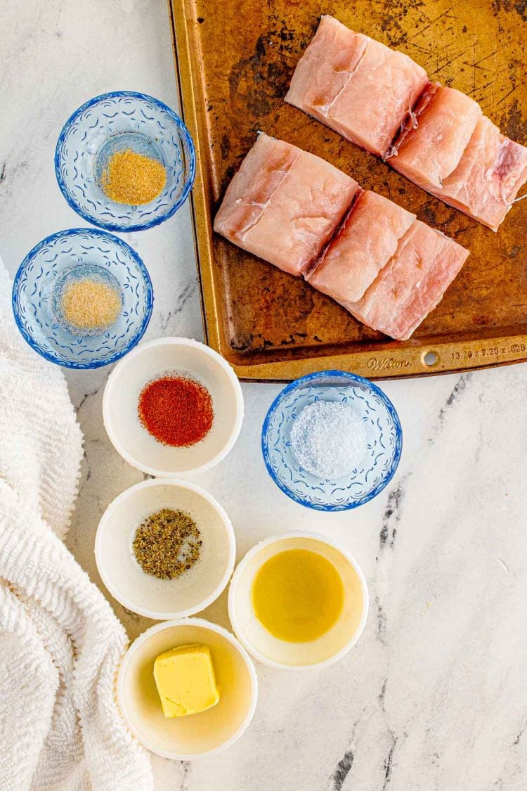 Ingredients prepped to make mahi mahi on the grill on a marble surface.