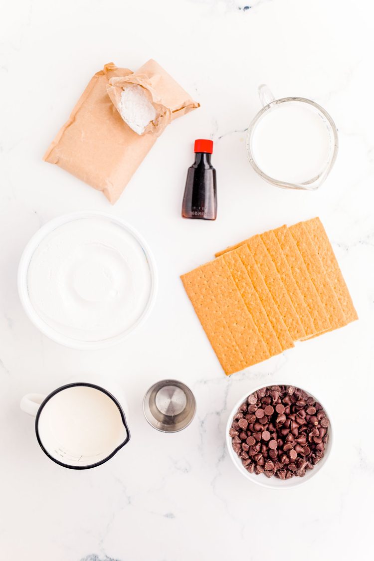 Ingredients to make Eclair Icebox Cake on a marble surface.