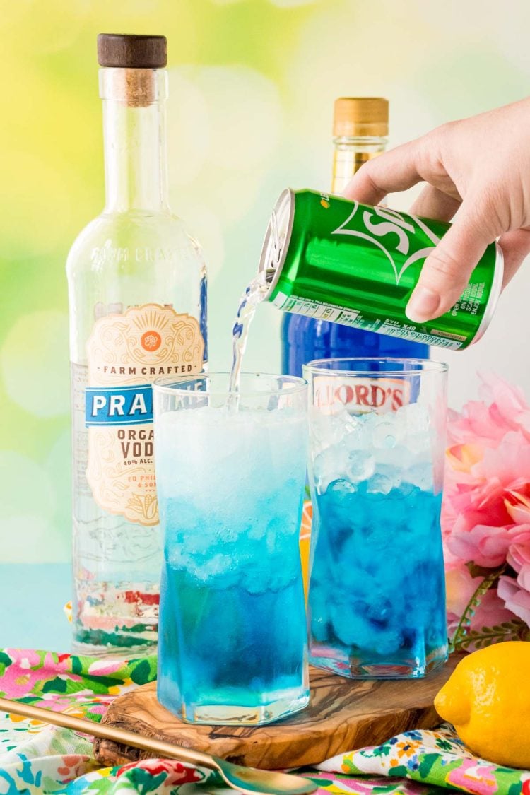 Sprite being poured into a blue cocktail.