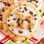 Close up of crumbl copycat cookie dough cookies on a red and green plaid plate.