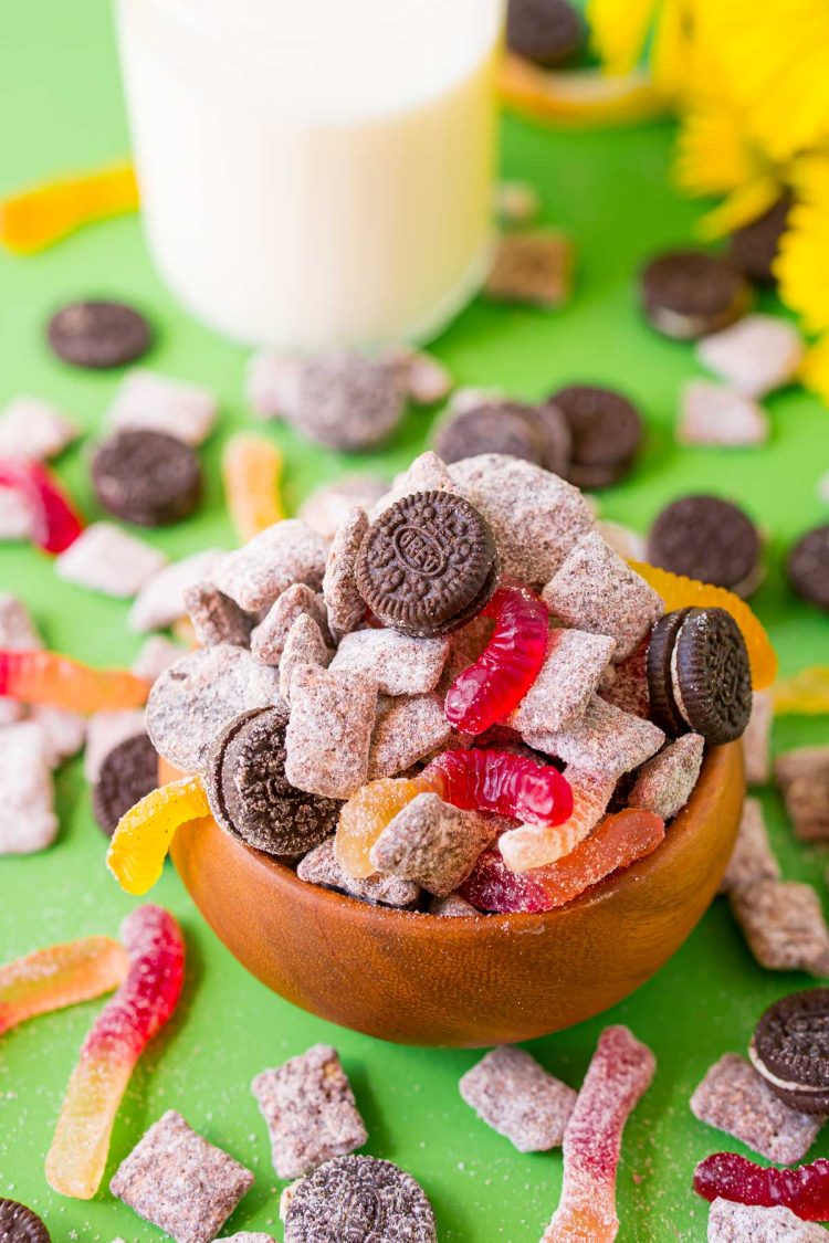 A wooden bowl filled with dirt cake muddy buddies.