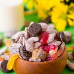 Close up photo of a wooden bowl with dirt cake muddy buddies in it.