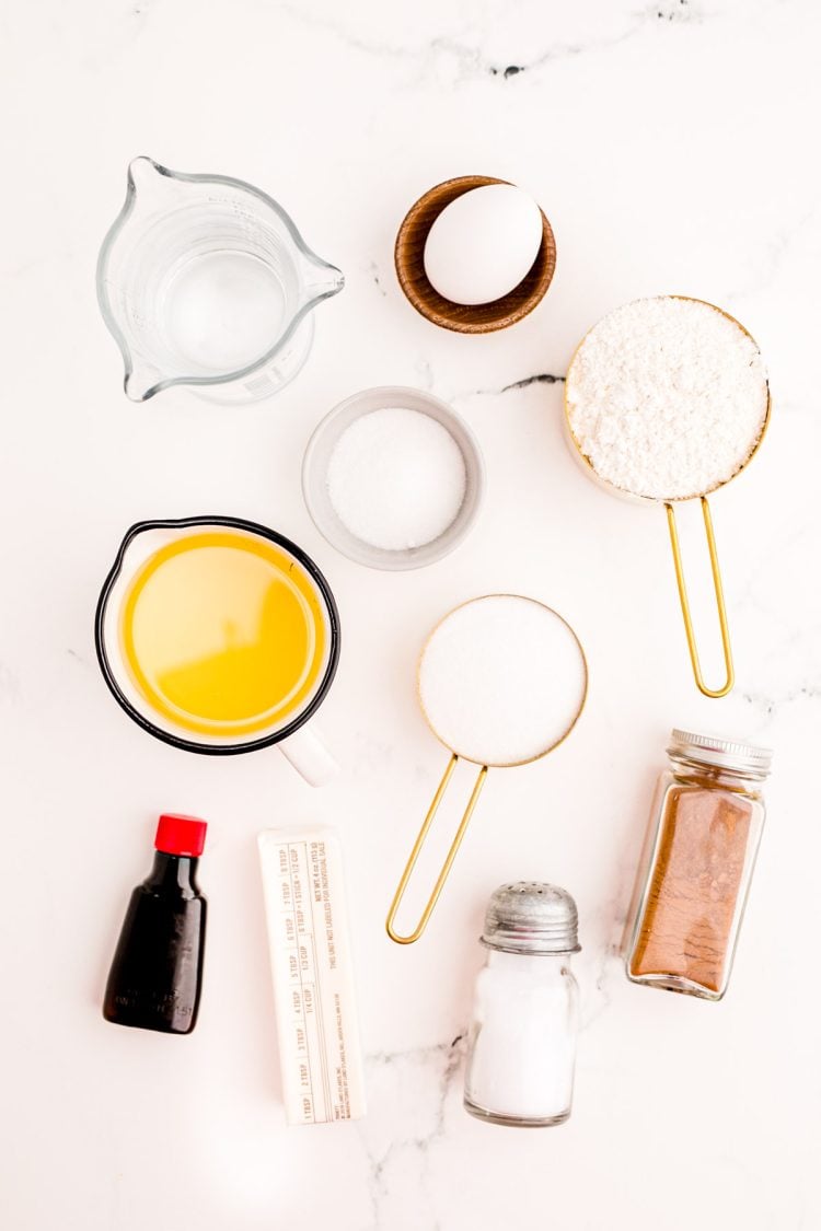 Ingredients to prepare churros on a marble counter.