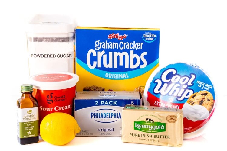 Ingredients to make no-bake-cheesecake on a white table.