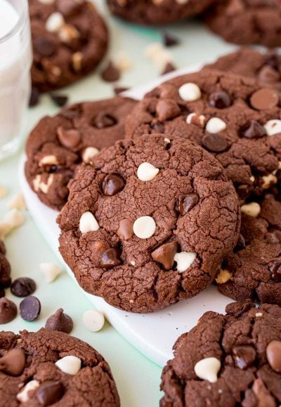 Triple chocolate chip cookies on a white board.