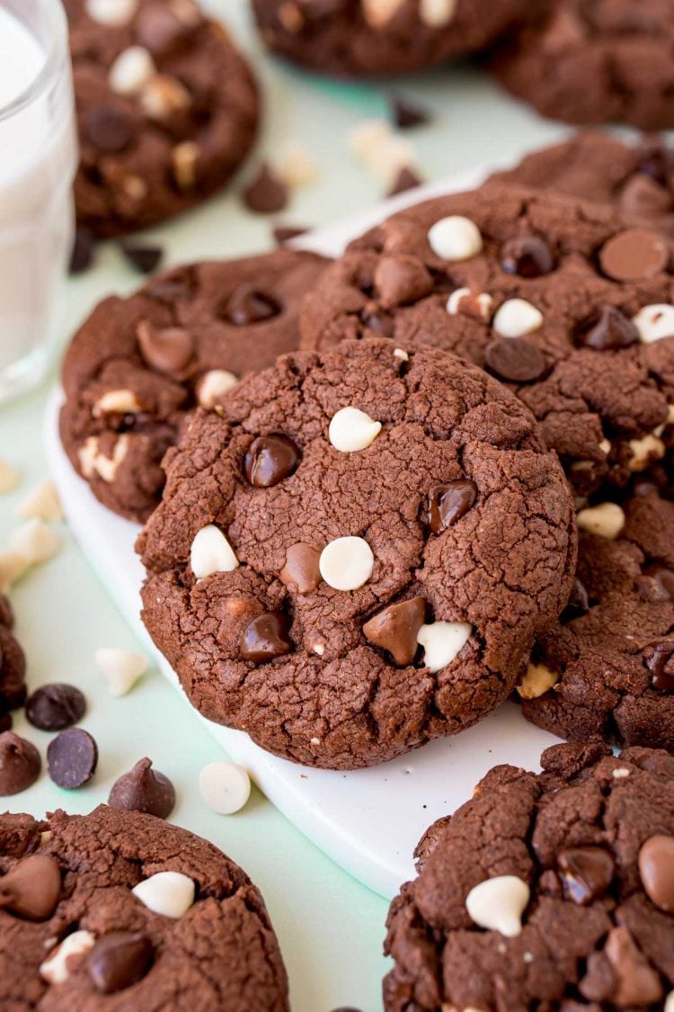 Triple chocolate chip cookies on a white board.