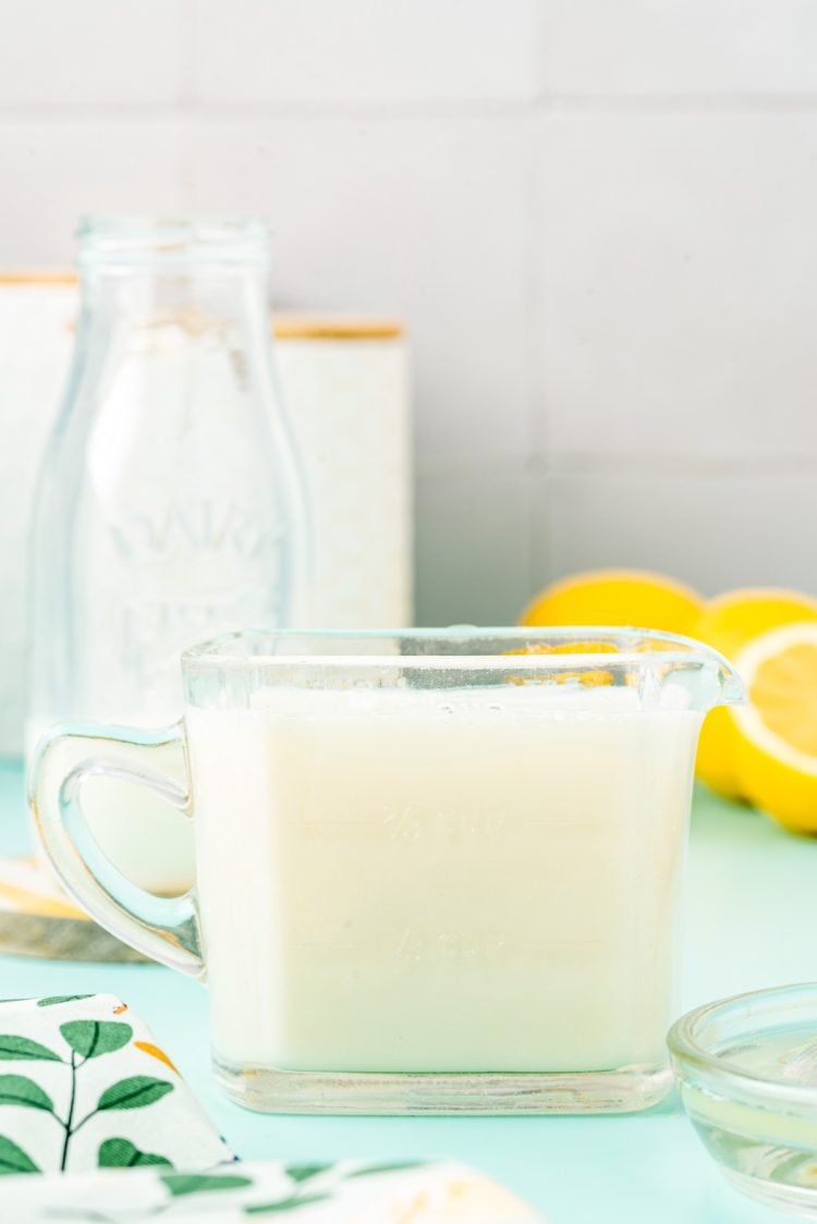 Measuring cup filled with a buttermilk substitute.