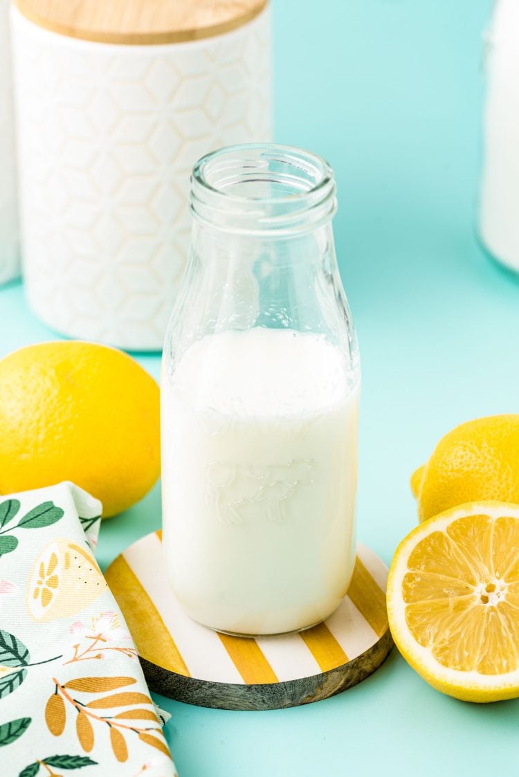 A glass milk bottle with buttermilk in it.