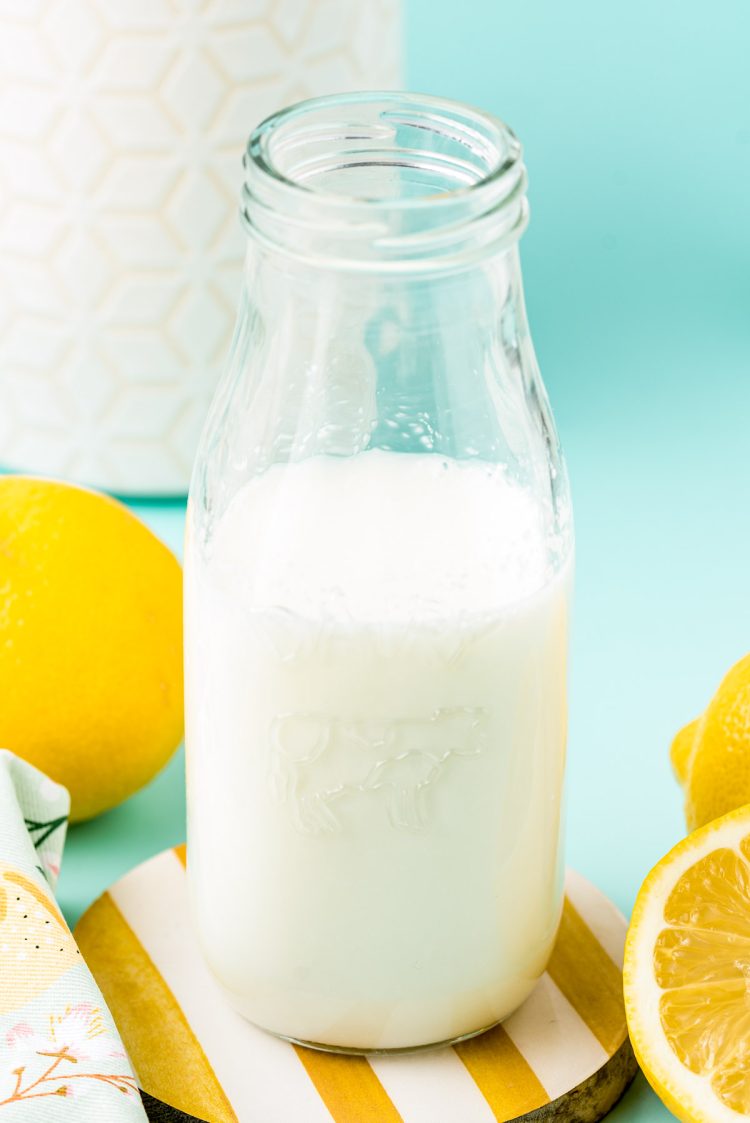 A glass milk bottle with buttermilk in it.