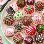 Overhead photo of Christmas decorated Oreo Balls on a white plate.