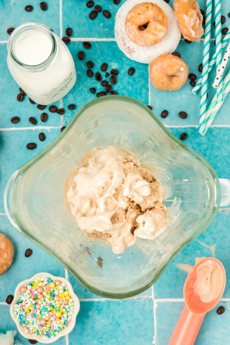 Ingredients to make a coffee milkshake in a blender.