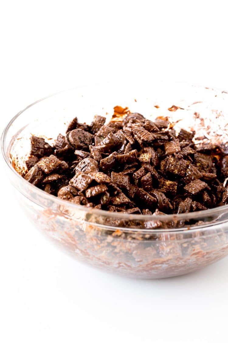 Muddy buddies being prepped in a glass mixing bowl.