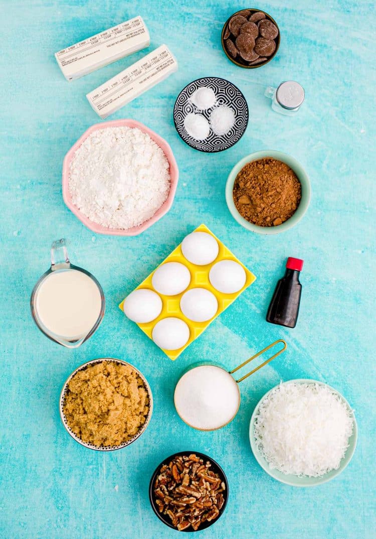 Ingredients to make German chocolate cake cookies on a blue surface.