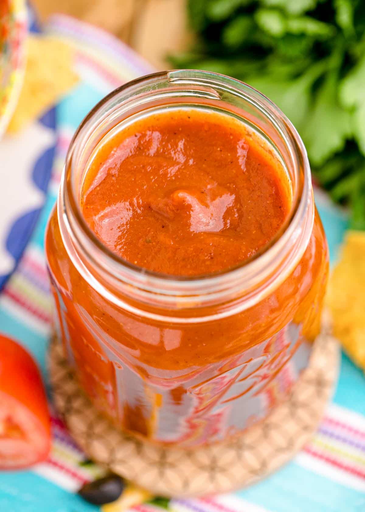 A mason jar filled with homemade enchilada sauce.