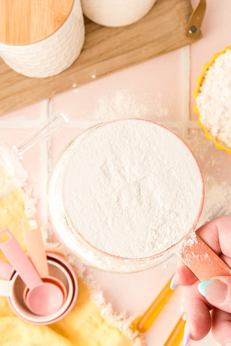 Overhead photo of a measuring cup with leveled flour in it.