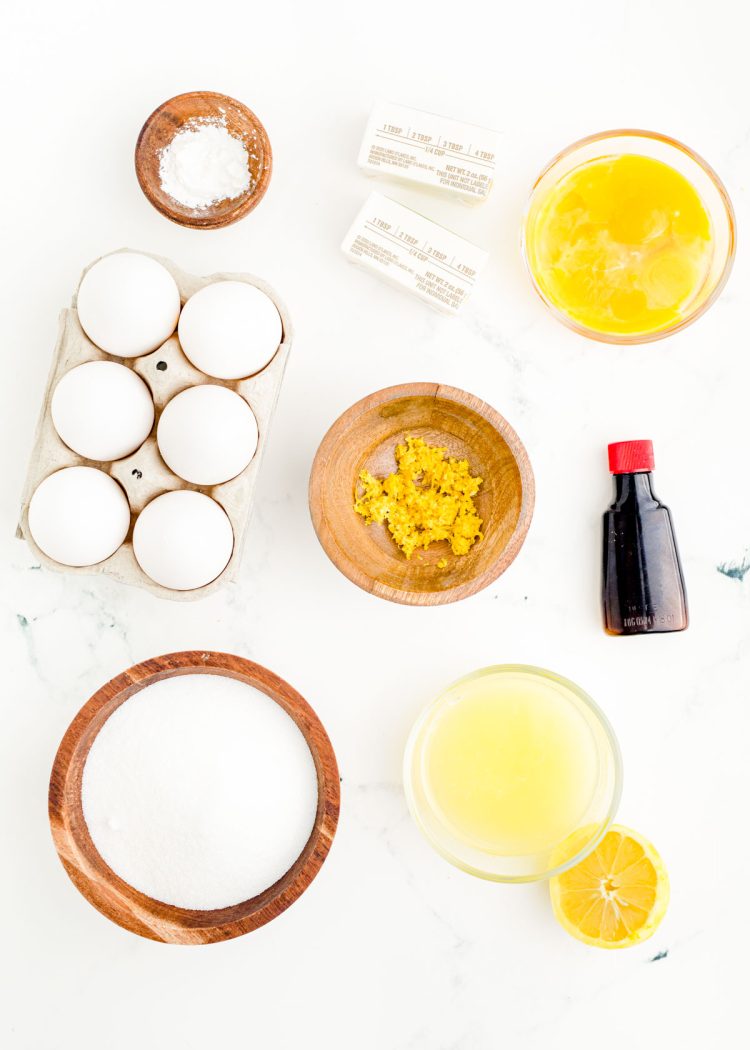 Ingredients to make lemon curd prepared on a marble surface.