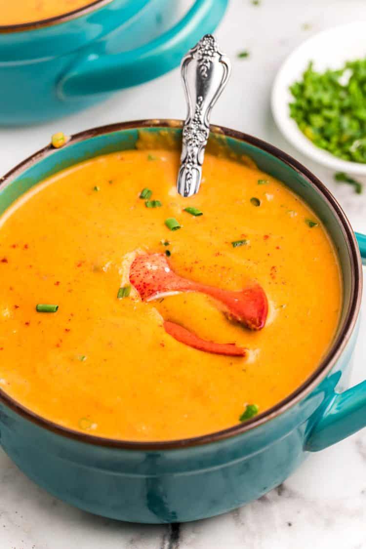 Lobster bisque in a teal bowl.