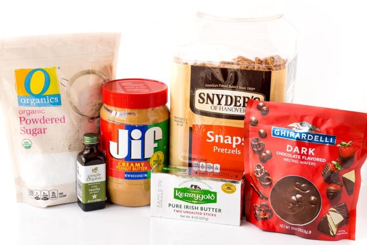 Ingredients to make peanut butter pretzel bites on a white surface.