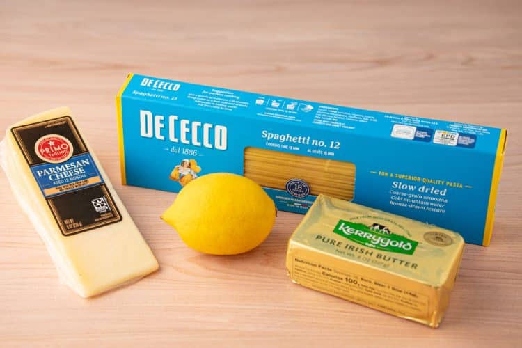 Ingredients to make spaghetti limone on a wooden table.