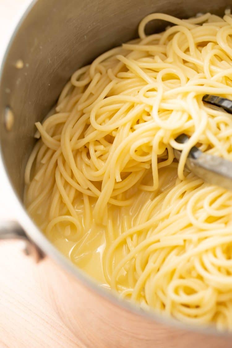 Spaghetti in a pot with lemon butter sauce.