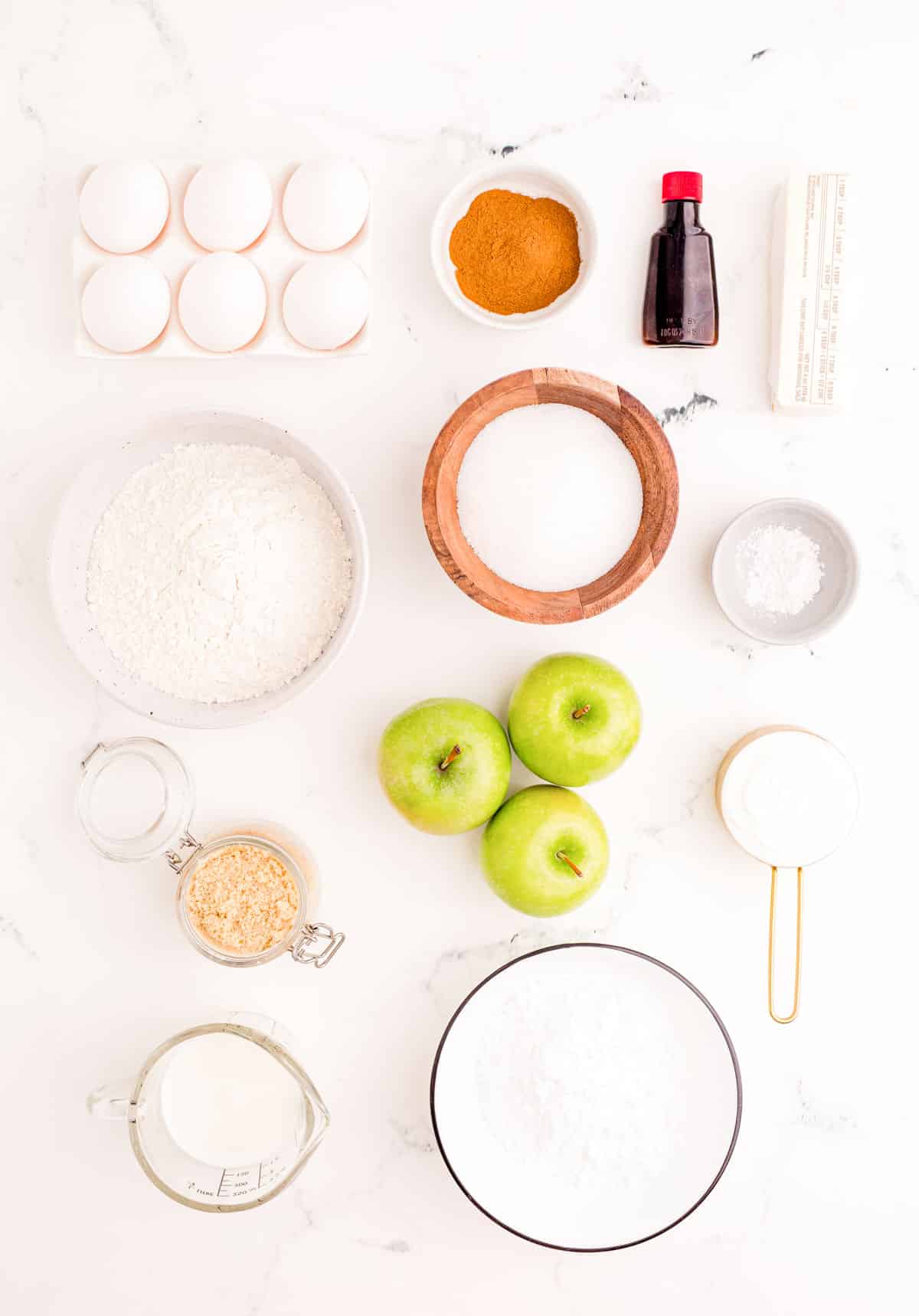 Ingredients to make apple fritter bread prepared on a marble surface.