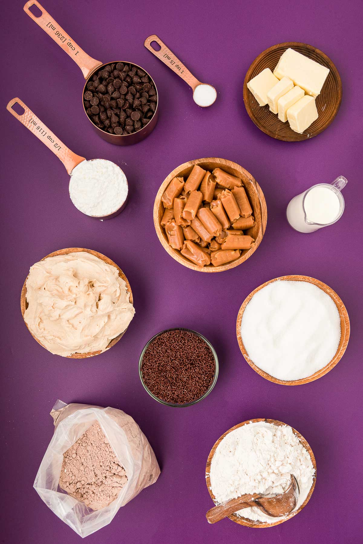 Overhead photo of ingredients to make billionaire bars on a purple surface. 
