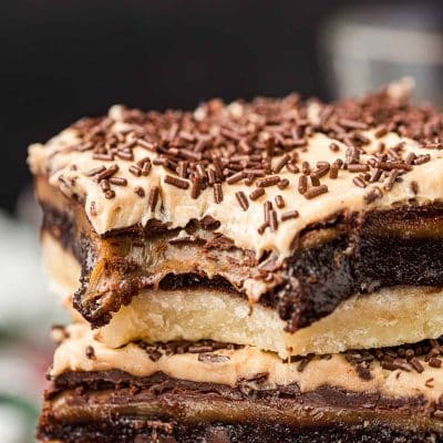 Billionaire bars stacked on top of each other with a bite missing from the top one.