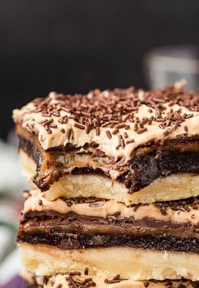 Billionaire bars stacked on top of each other with a bite missing from the top one.